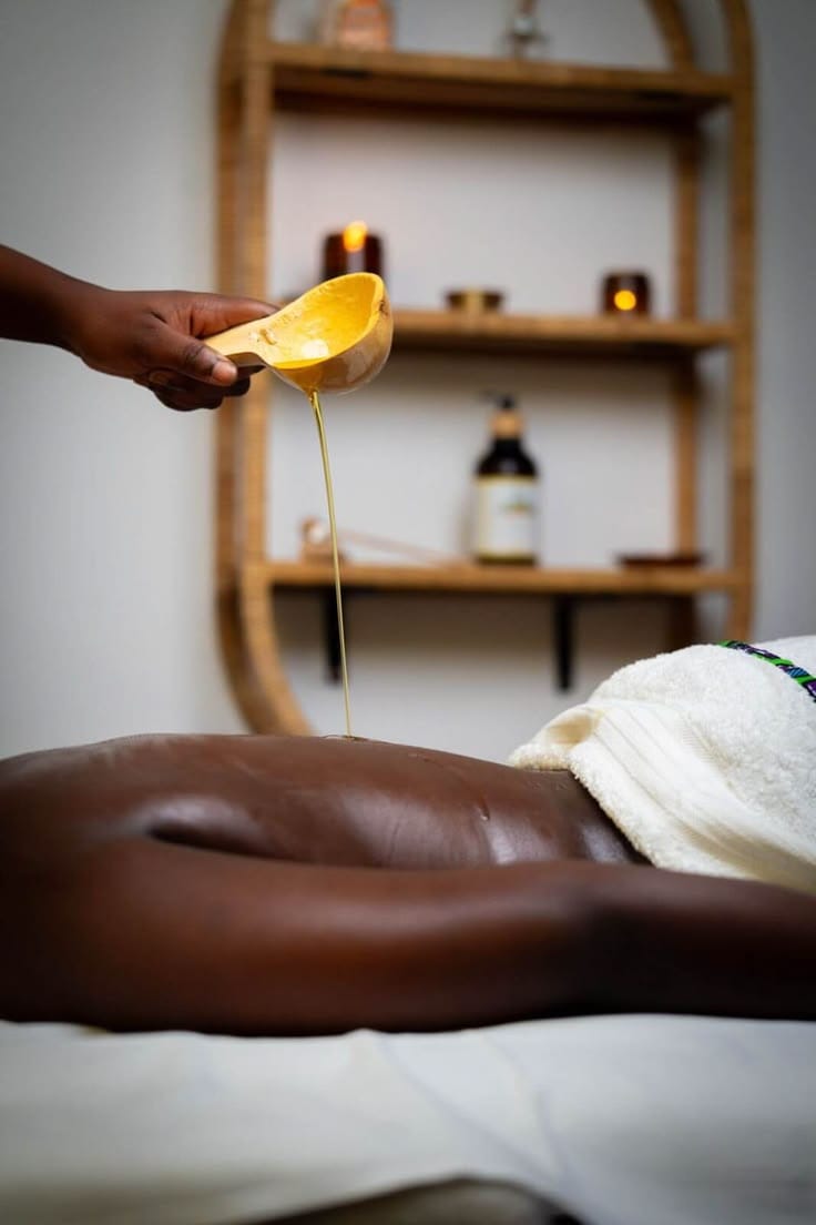 Warm oil being poured for a back massage